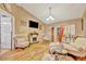 Bright living room featuring laminate flooring, fireplace, and a neutral color palette at 1505 E 99Th Ave, Tampa, FL 33612