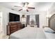 Cozy main bedroom with a large bed, dresser, and vanity, offering a comfortable and stylish space at 1525 W Comanche Ave, Tampa, FL 33603