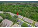 Community of neutral townhouses nestled among trees, offering parking, and maintained landscaping at 15855 Fishhawk View Dr, Lithia, FL 33547