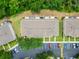 Birds eye view of the property showing the parking area, roofline and well maintained green spaces between each building at 15855 Fishhawk View Dr, Lithia, FL 33547