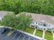 Aerial view of townhouse with neutral exterior, blue shutters, updated roof, and assigned parking at 15855 Fishhawk View Dr, Lithia, FL 33547