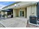 Covered back patio with neutral colors, concrete flooring and sliding glass doors provides a relaxing outdoor space at 15855 Fishhawk View Dr, Lithia, FL 33547