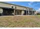 Townhouse with screened patio, covered porch, and lawn create a comfortable outdoor living space at 15855 Fishhawk View Dr, Lithia, FL 33547