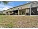 Backyard of townhouse with screened patio and outdoor seating provides a relaxing space to entertain and enjoy at 15855 Fishhawk View Dr, Lithia, FL 33547