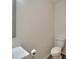 Cozy bathroom with a toilet and wood-look tile floor at 15855 Fishhawk View Dr, Lithia, FL 33547