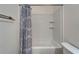A clean bathroom with a shower-tub combination and a patterned shower curtain at 15855 Fishhawk View Dr, Lithia, FL 33547