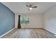 Expansive bedroom with accent wall, large window, and modern flooring at 15855 Fishhawk View Dr, Lithia, FL 33547