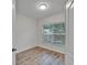 Bedroom featuring neutral walls and durable wood-look flooring with natural light at 15855 Fishhawk View Dr, Lithia, FL 33547