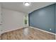 Bedroom featuring hardwood floors and a light blue accent wall at 15855 Fishhawk View Dr, Lithia, FL 33547