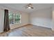 Bright bedroom featuring hardwood floors, a ceiling fan, and a window providing natural light at 15855 Fishhawk View Dr, Lithia, FL 33547