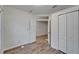 This bedroom offers wood-look flooring, an open doorway, and closet for storage at 15855 Fishhawk View Dr, Lithia, FL 33547