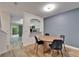 Dining area with wood floors featuring a round wooden table with four chairs near kitchen at 15855 Fishhawk View Dr, Lithia, FL 33547