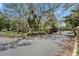 Well maintained gate and entry area with mature trees and lush shrubbery; a beautiful welcome home at 15855 Fishhawk View Dr, Lithia, FL 33547