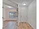 View from the entryway into a naturally lit bedroom with wood-look flooring at 15855 Fishhawk View Dr, Lithia, FL 33547