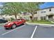 Exterior view of the townhome featuring a red car parked in designated parking spot at 15855 Fishhawk View Dr, Lithia, FL 33547