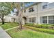 Townhouse with neutral exterior, well-maintained landscaping, and inviting entrance offers comfortable and stylish living at 15855 Fishhawk View Dr, Lithia, FL 33547