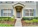 Charming front exterior featuring blue shutters and well-maintained landscaping at 15855 Fishhawk View Dr, Lithia, FL 33547
