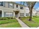 Charming two-story townhouse featuring blue shutters, neutral siding, landscaping, and inviting front entrance at 15855 Fishhawk View Dr, Lithia, FL 33547