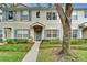 Charming townhome with blue shutters and lush landscaping in a well-maintained community at 15855 Fishhawk View Dr, Lithia, FL 33547