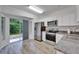 Bright eat-in kitchen features stainless steel appliances and a sliding glass door to a patio at 15855 Fishhawk View Dr, Lithia, FL 33547