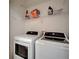 Laundry room with front-load washer and dryer plus ample storage space at 15855 Fishhawk View Dr, Lithia, FL 33547