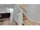 Inviting living room featuring durable wood-look flooring and staircase at 15855 Fishhawk View Dr, Lithia, FL 33547