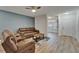 Comfortable living area featuring an accent wall, ceiling fan and access to other rooms at 15855 Fishhawk View Dr, Lithia, FL 33547