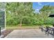 Outdoor patio area featuring a seating arrangement and lush backyard view at 15855 Fishhawk View Dr, Lithia, FL 33547