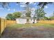 An image of the partially-fenced backyard with deck/porch attached to the home at 1801 E Navajo Ave, Tampa, FL 33612