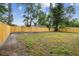 View of the backyard featuring a new wooden fence at 1801 E Navajo Ave, Tampa, FL 33612