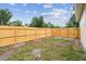 Spacious, partially-fenced backyard with sparse grass at 1801 E Navajo Ave, Tampa, FL 33612