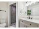 Modern bathroom featuring updated vanity, fixtures, and tiled shower with glass doors at 1801 E Navajo Ave, Tampa, FL 33612