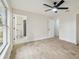 Spacious bedroom with ensuite bathroom, ceiling fan, and modern wood-look tile floors at 1801 E Navajo Ave, Tampa, FL 33612