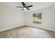 Bright bedroom featuring a ceiling fan, natural light and modern wood-look tile flooring at 1801 E Navajo Ave, Tampa, FL 33612