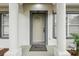 Close-up of the inviting front door with decorative accents and a 'Welcome' mat at 1801 E Navajo Ave, Tampa, FL 33612