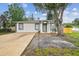 Inviting single-story home featuring a well-manicured lawn and a neutral-colored exterior at 1801 E Navajo Ave, Tampa, FL 33612