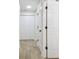 Hallway with multiple closets, interior doors, and wood-look tile flooring at 1801 E Navajo Ave, Tampa, FL 33612