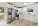Modern kitchen with stainless steel appliances, white cabinets, and stylish tile flooring at 1801 E Navajo Ave, Tampa, FL 33612