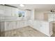 Spacious kitchen featuring white cabinets, modern countertops, and stylish backsplash at 1801 E Navajo Ave, Tampa, FL 33612