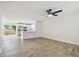 Open-concept living room with tile floors, a ceiling fan, and plenty of natural light at 1801 E Navajo Ave, Tampa, FL 33612