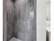 Updated tiled shower with modern fixtures and neutral color palette at 1801 E Navajo Ave, Tampa, FL 33612