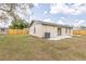 Backyard with partial view of home, wooden fence, and AC unit at 1818 Kim Acres Ln, Dover, FL 33527