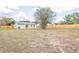 Spacious backyard with wooden fence and view of the home at 1818 Kim Acres Ln, Dover, FL 33527
