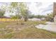 View of the expansive backyard featuring a wooden fence, trees, and the back of the house at 1818 Kim Acres Ln, Dover, FL 33527