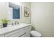 Charming bathroom featuring a modern vanity with granite countertops and a stylish blue-tiled shower at 1818 Kim Acres Ln, Dover, FL 33527