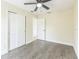 Empty bedroom featuring wood floors, natural light, closet space and a ceiling fan at 1818 Kim Acres Ln, Dover, FL 33527