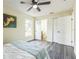Bedroom featuring wood floors, a ceiling fan, and a view of an en-suite bathroom at 1818 Kim Acres Ln, Dover, FL 33527