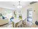 Bright dining area featuring a modern table set, tile floors and natural light at 1818 Kim Acres Ln, Dover, FL 33527