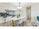 Open layout with dining area, table, and view to the kitchen with barstool seating at 1818 Kim Acres Ln, Dover, FL 33527
