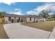 Charming single-story home with a well-maintained lawn and a long concrete driveway at 1818 Kim Acres Ln, Dover, FL 33527